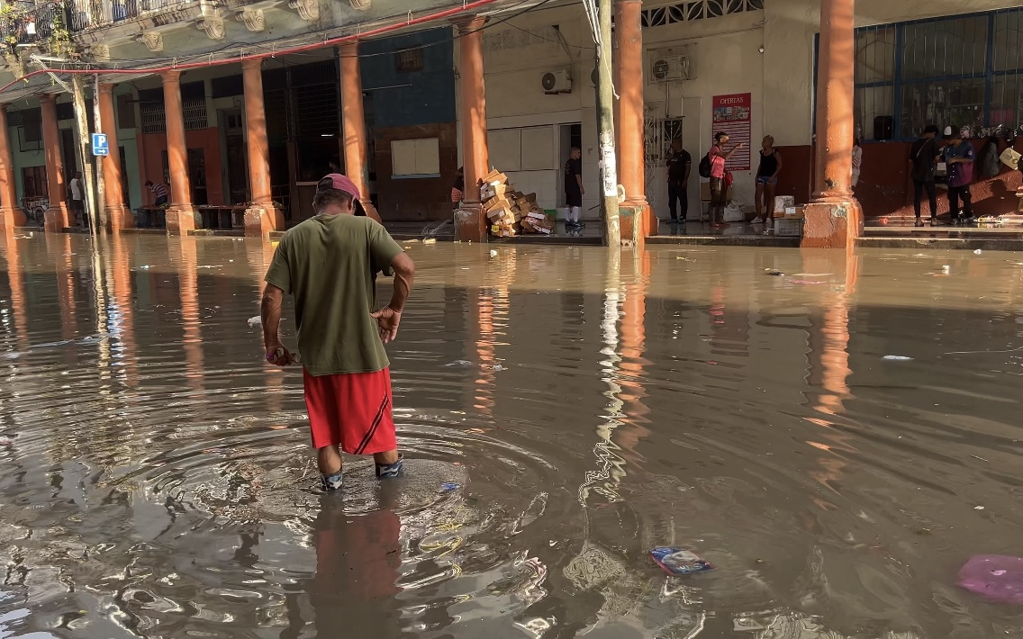 Rain and clogged sewers form a black and stinking river in Havana